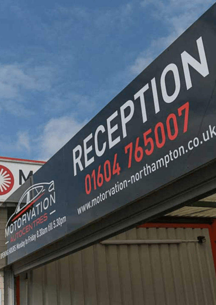 The sign for the Reception at Motorvation Northampton and the telephone number 01604 765007 to book air con re-gas.